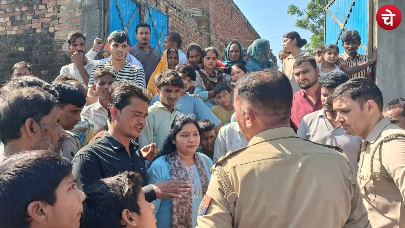 Police officer speaking with the family of student Bhavna